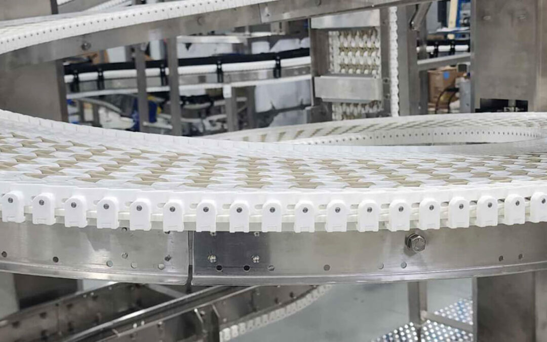 Close-up view of SpanTech plastic-chain spiral conveyor curve moving products smoothly around a tight 360° turn in a food-grade packaging line.