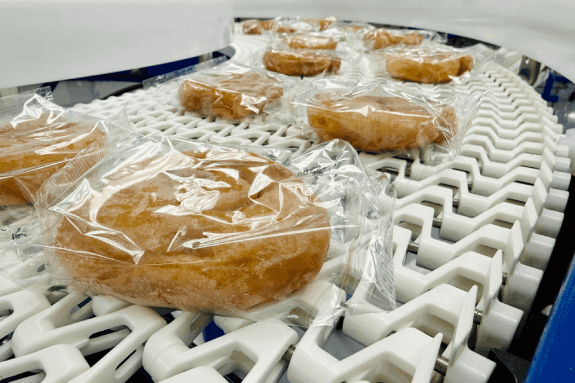 Packaged baked goods on a conveyor.